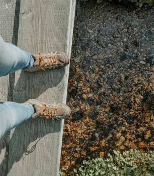 An AI cannot guide: a pair of feet at the edge of a walkway leading into the void