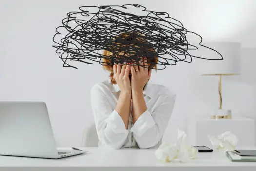 Reducing stress and improving conflict management at work: woman sitting with dark clouds above her head